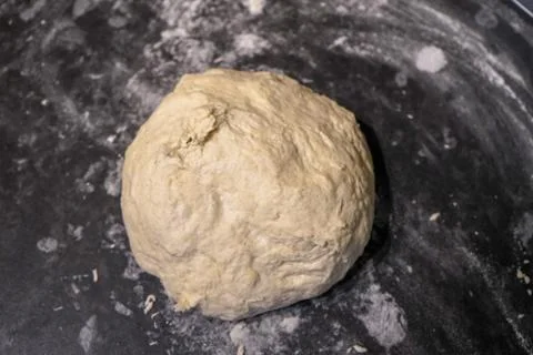 Uncooked bread dough on a kitchen surface Stockfoto's