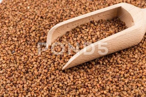 Uncooked Buckwheat On Wooden Spoon