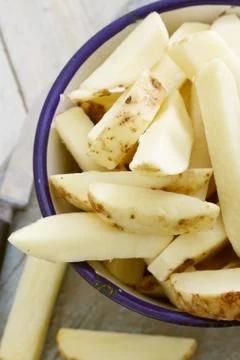 Uncooked chipped potatoes Stock Photos
