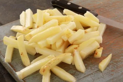 Uncooked chipped potatoes Stock Photos