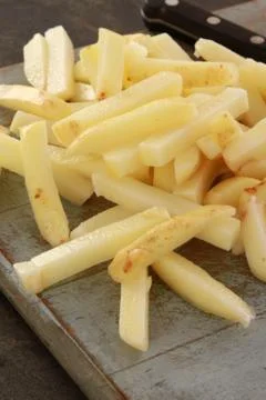 Uncooked chipped potatoes Stock Photos