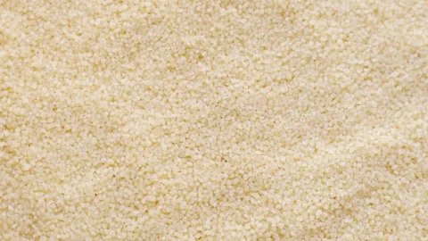Uncooked couscous grains circle rotation close up top view Stock Footage 263215196