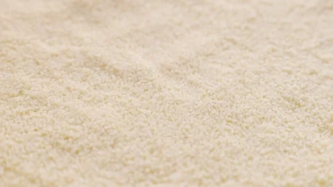 Uncooked couscous grains falling down close up Stock Footage 263809026