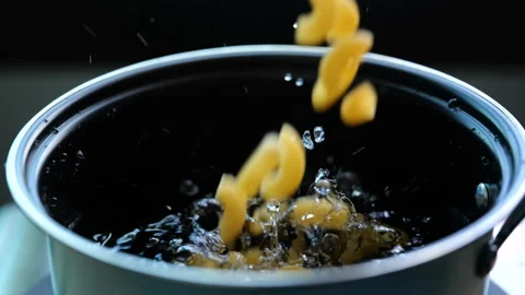 Uncooked elbow macaroni falling down into the pot in slow motion 스톡 동영상 156227976