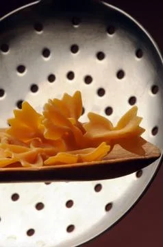 Uncooked Farfalle on the spoon Stock Photos