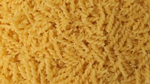 Uncooked fusilli pasta texture background shot Stock Footage 341823006