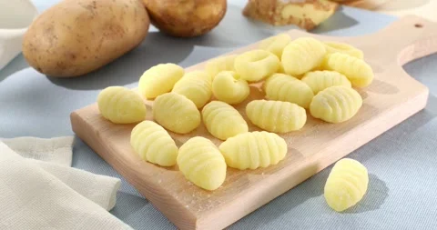 Uncooked gnocchi on cutting board Stock Footage 240912832