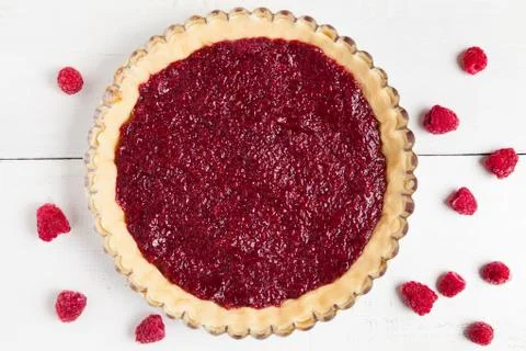 Uncooked homemade pie with raspberry jam preparation on white kitchen table Stock Photos