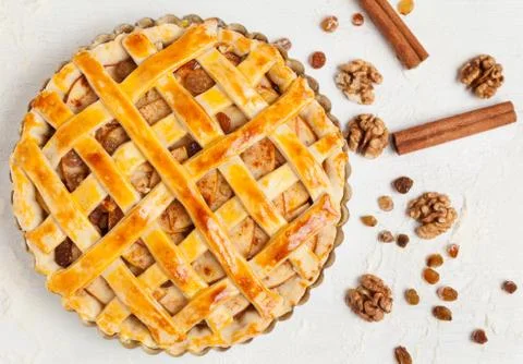 Uncooked homemade rustic apple pie preparation greased with egg yolk Stock Photos
