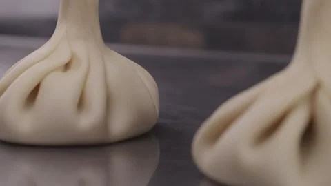 Uncooked khinkali dumplings lying on the table close-up. Stock Footage 314241967
