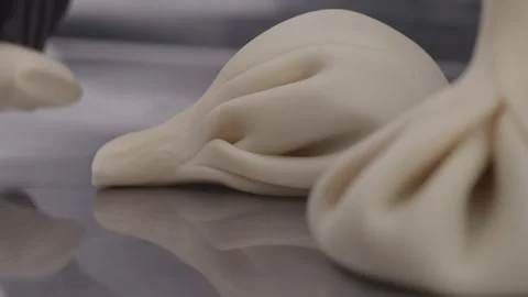 Uncooked khinkali dumplings lying on the table close-up. Stock Footage 314241990