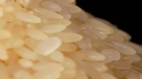 Uncooked Long Grain Parboiled Rice Rotating - Macro Stock Footage 201410383