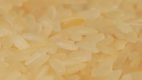 Uncooked Long Grain Parboiled Rice Rotating - Macro Stock Footage 217396392