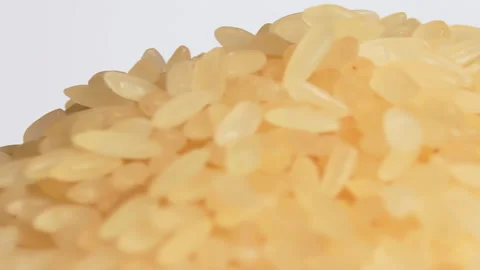 Uncooked Long Grain Parboiled Rice Rotating - Macro Stock Footage 229843433