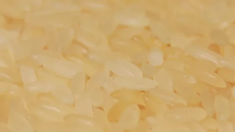 Uncooked Long Grain Parboiled Rice Rotating - Macro Stock Footage 252408749