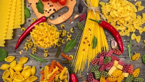 Uncooked macaroni and pasta on table Stock Footage 151162803