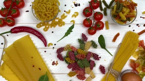 Uncooked macaroni and pasta on table Stock Footage 151162811