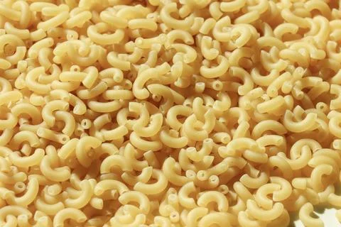 Uncooked macaroni elbow pasta uncooked texture Fotos de archivo