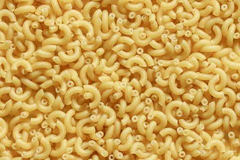 Uncooked macaroni elbow pasta uncooked texture Fotos de archivo