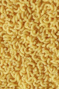 Uncooked macaroni pasta ingredient top view Stock Photos
