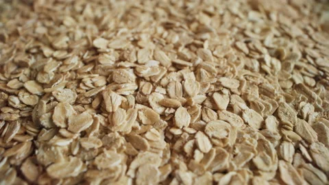 Uncooked oatmeal flakes rotating close-up Stock Footage 195945946