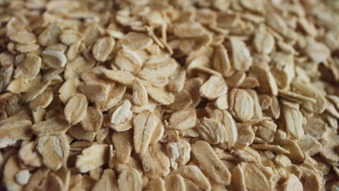 Uncooked oatmeal flakes rotating macro Stock Footage 195945986