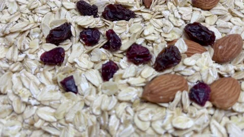 Uncooked oatmeal flakes texture and almonds and dry cranberry close up. Macro Stock Footage 159582943