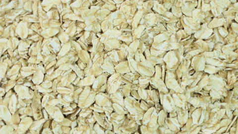 Uncooked oatmeal flakes texture close up. Macro shot. Rotation. Oatmeal. Oat Stock Footage 188322438
