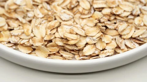 Uncooked oatmeal flakes texture close up Stock Footage 234992924
