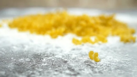 Uncooked pasta. close-up. Cavatappi pasta lies in white flour on a wooden table Stock Footage 112270606