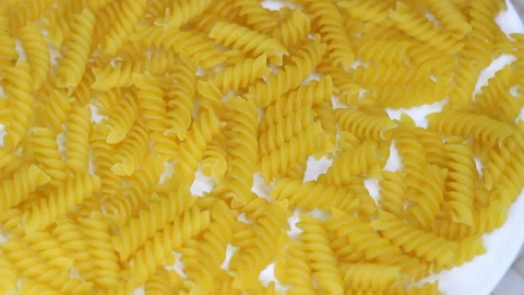 Uncooked Pasta - Top View. Fat and Unhealthy Food. Dry Spiral Macaroni, Rotating Stock Footage 255832308