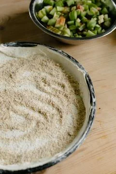 Uncooked pie dough in flat baking pan and fresh cut green rhubarb stalks on Stock Photos