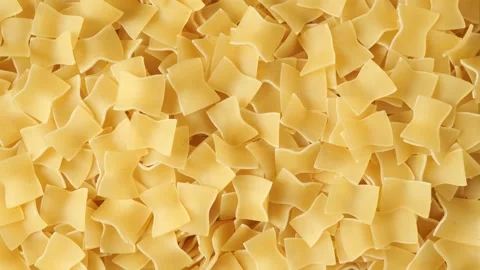 Uncooked quadretti pasta slowly moving top view Stock Footage 340526332