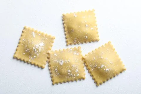 Uncooked ravioli on white table, flat lay 写真素材