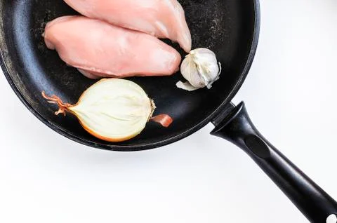 Uncooked Raw Chicken Breasts, Fillets, Chopped Half Onion, Whole Garlic Bulb Stock Photos