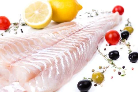 Uncooked raw fillet  of cod with serving spices Stock Photos