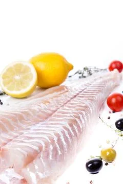 Uncooked raw fillet  of cod with serving spices Stock Photos