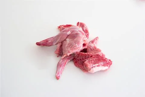 Uncooked raw rabbit or hare legs. Close up top view studio shot, no people Fotos de archivo