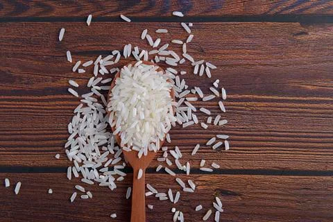 Uncooked rice in a spoon Stock Photos