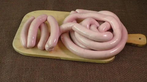 Uncooked sausage on the chopping board Stock Footage 59603137