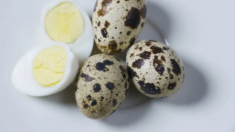 Uncooked scattered Quail eggs on white background top view, healthy food concept Stock Footage 98996645