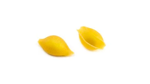 Uncooked shell pasta on white background. Stock Photos
