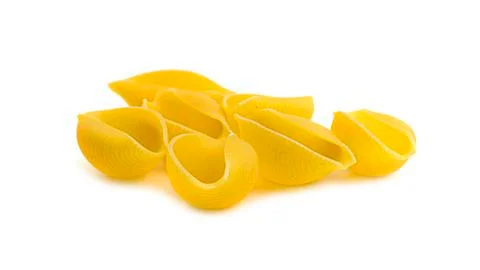 Uncooked shell pasta on white background. Stock Photos