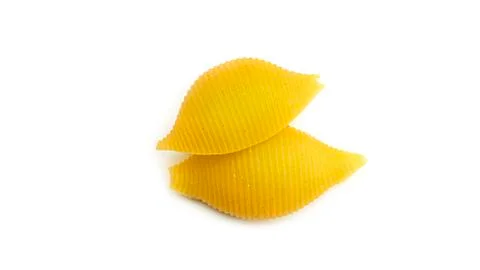 Uncooked shell pasta on white background. Stock Photos