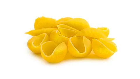 Uncooked shell pasta on white background. Stock Photos