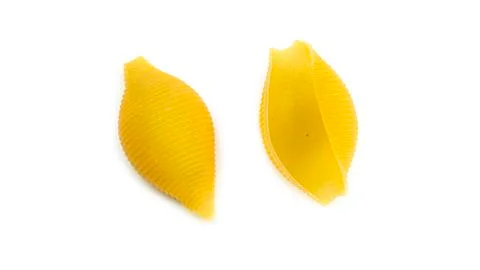 Uncooked shell pasta on white background. Stock Photos