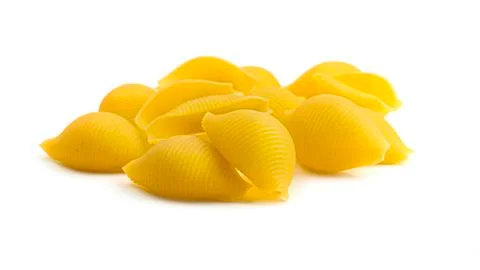 Uncooked shell pasta on white background. Stock Photos