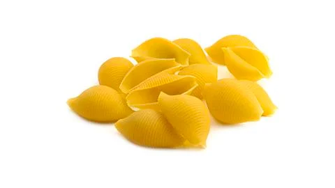 Uncooked shell pasta on white background. Stock Photos