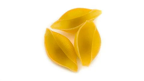 Uncooked shell pasta on white background. Stock Photos