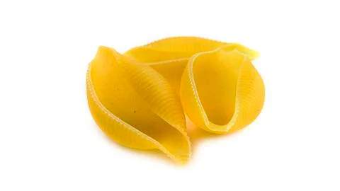 Uncooked shell pasta on white background. Stock Photos